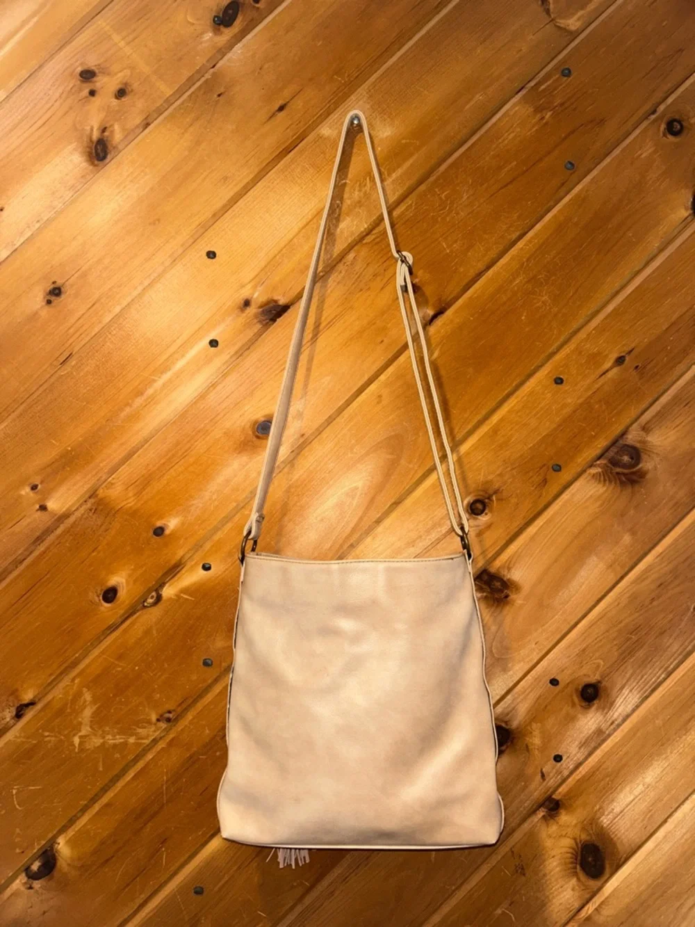 Western style tan crossbody bag with braided & tassels accents